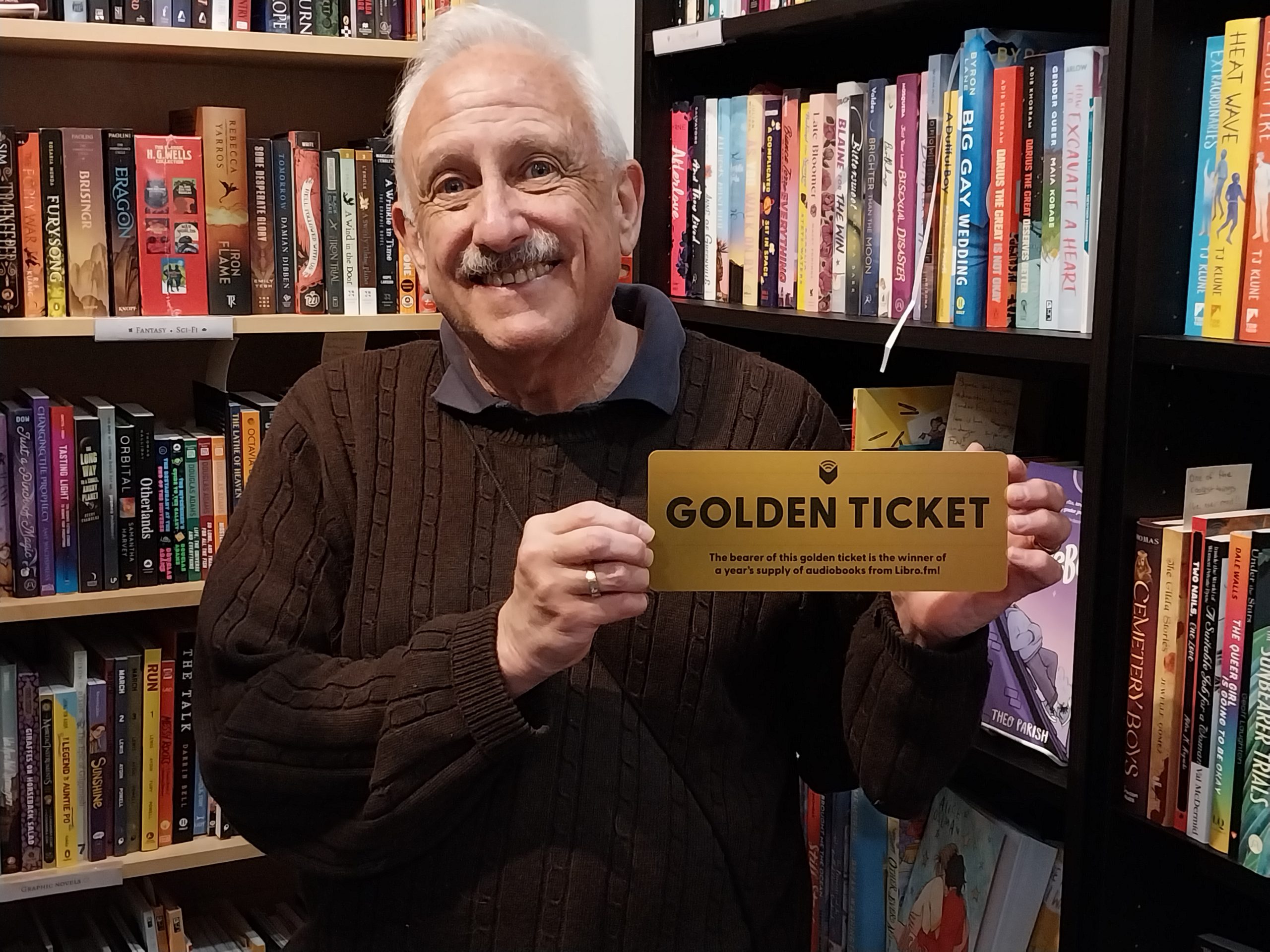 Craig holding a Golden Ticket for a year of free audio books